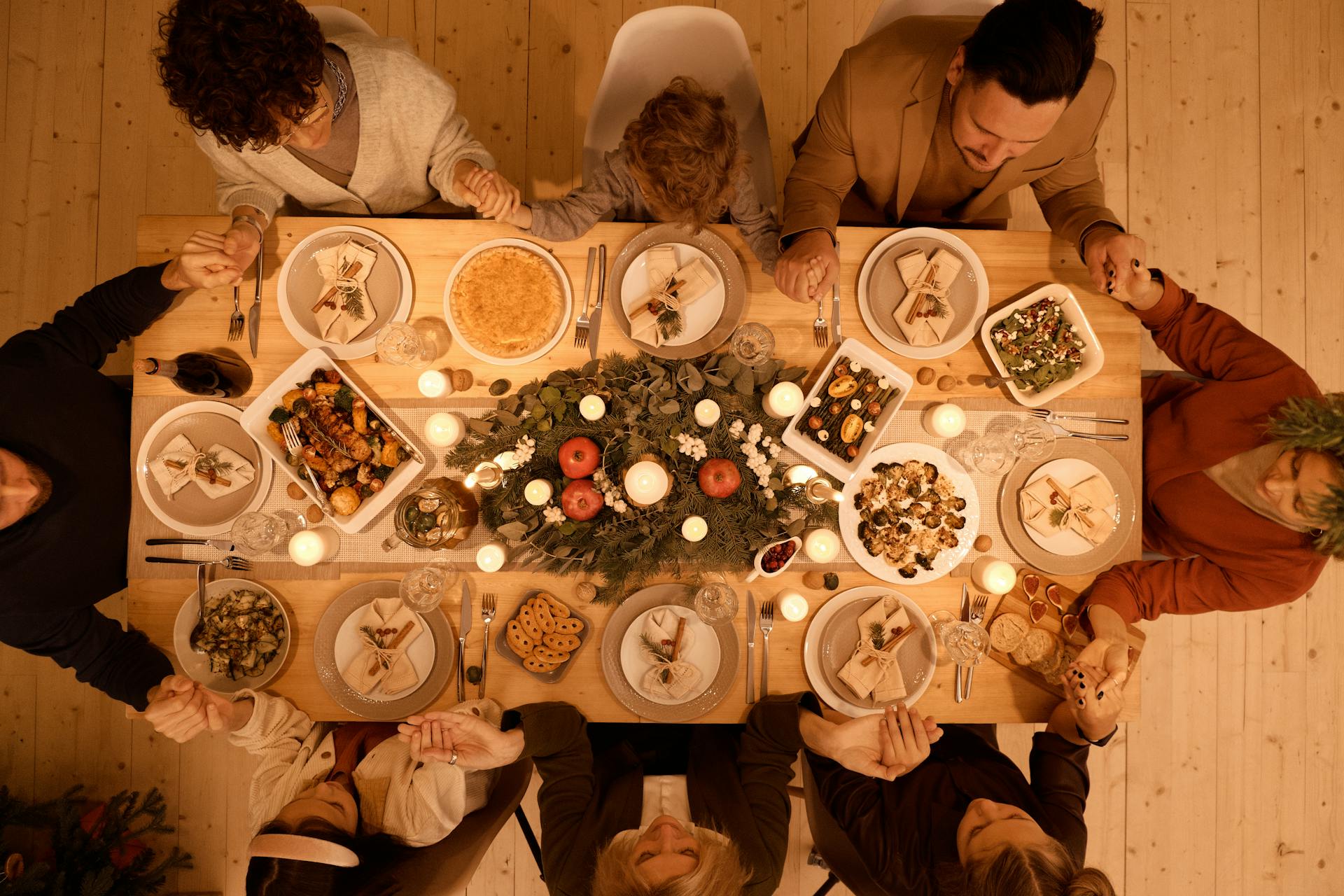 top view of family celebrating christmas around dinner table top view of family celebrating christmas around dinner table