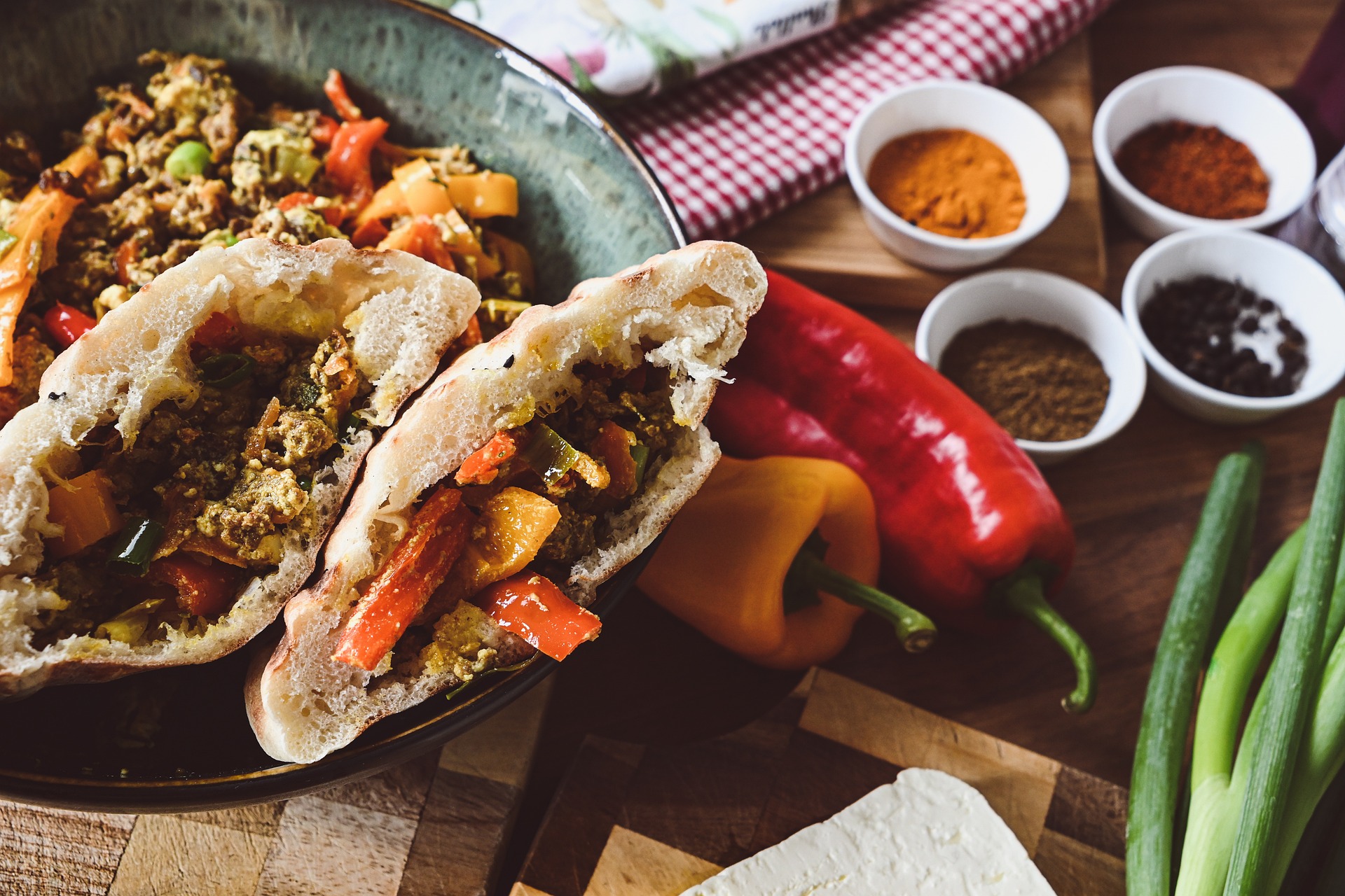 sandwiches filled with meat and vegetables on wooden table with spices sandwiches filled with meat and vegetables on wooden table with spices