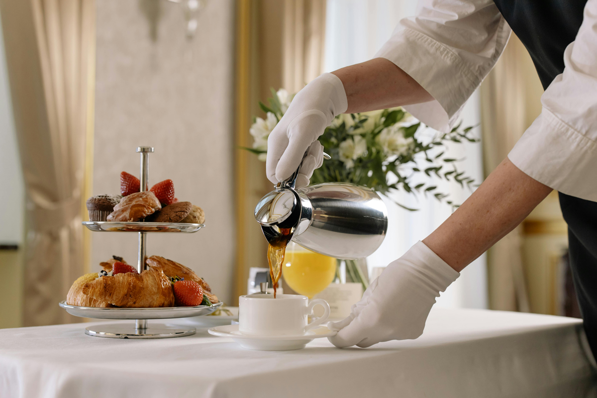brunch catering Brunch catering setup with a person pouring coffee into a cup.