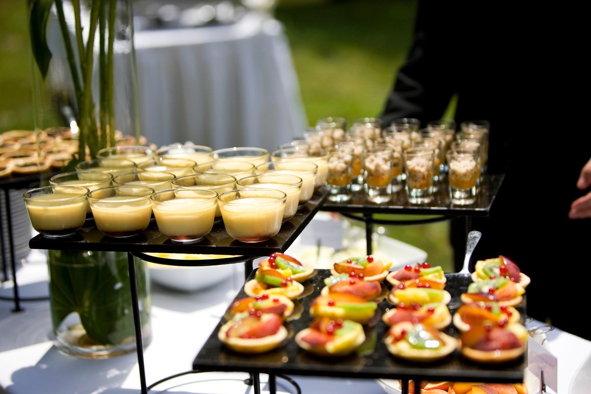 pics - 2 A beautifully arranged outdoor buffet table featuring an assortment of elegant desserts.